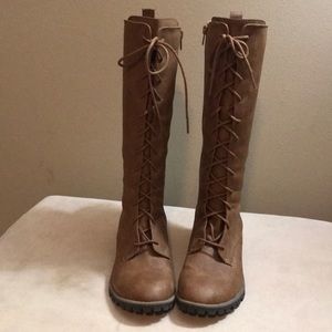 Brown boots with lace up detail.